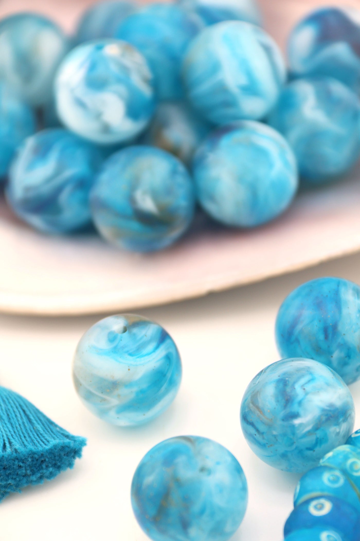 Beads that look like earth, sitting in a large shell.