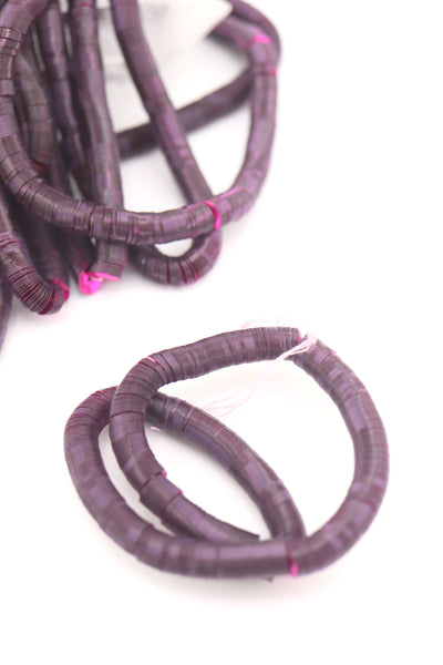 Strand of flat 6mm burgundy red sequins, vintage Belgium stock from the early 1900s, glowing against a light background.