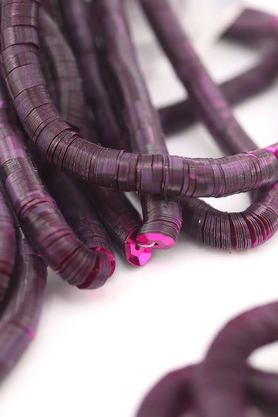 Strands of flat 6mm burgundy red sequins, vintage Belgium stock from the early 1900s, glowing against a light background.
