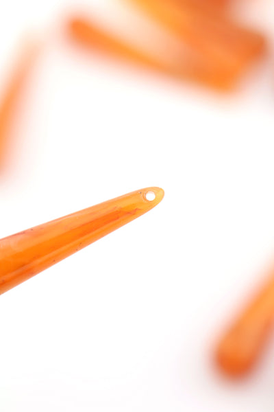 closeup of orange teardrop bead