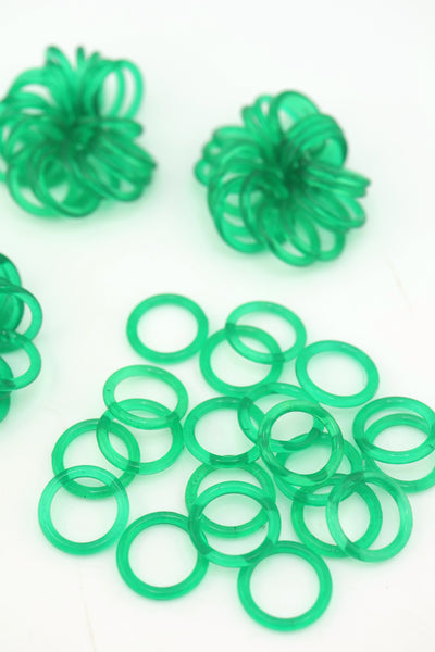 Translucent 18mm Green Vintage German Resin Rings in bundles on a white background