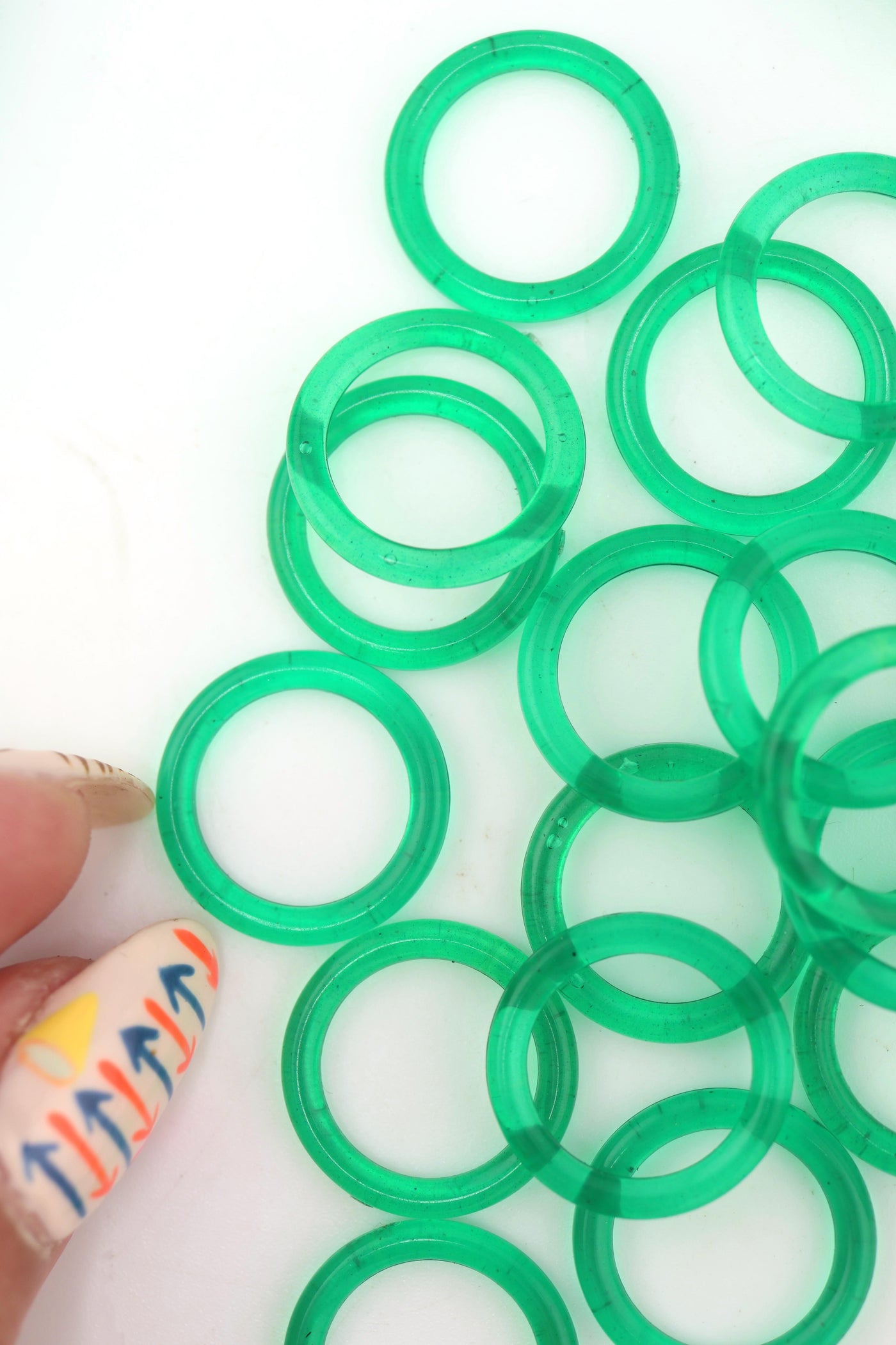 Translucent 18mm Green Vintage German Resin Rings in bundles on a white background