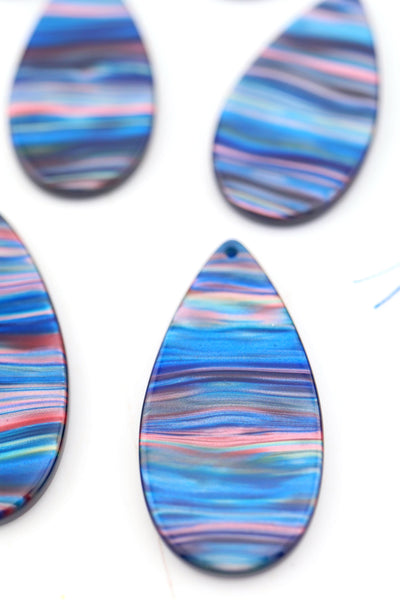Closeup of Blue Galaxy Waves Teardrop Laser Cut Italian Poly Resin Pendant 46mm, 1 Charm for making DIY jewelry and earrings