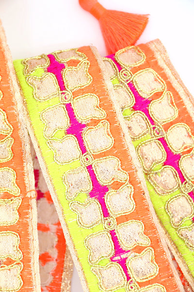 Neon embroidered sari trim with clover design and gold metallic thread. Great for sewing, crafting, embellishment, and DIY decor. Sold by the yard.