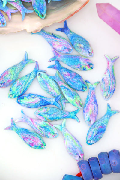 Resin fish charms in multicolor pastel aurora finish, styled for jewelry making and DIY crafts