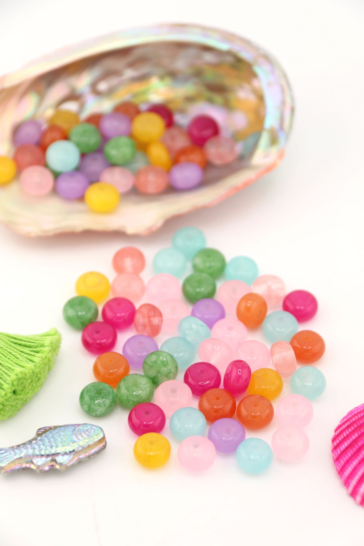 Pastel Rainbow Gemstone Beads, Loose Beads for DIY Necklace, shown spilling out of a large seashell.