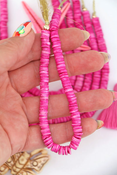 Bright Pink Bone Heishi Disc Beads, 7mm, 100+ beads on a strand, in the palm of a hand.