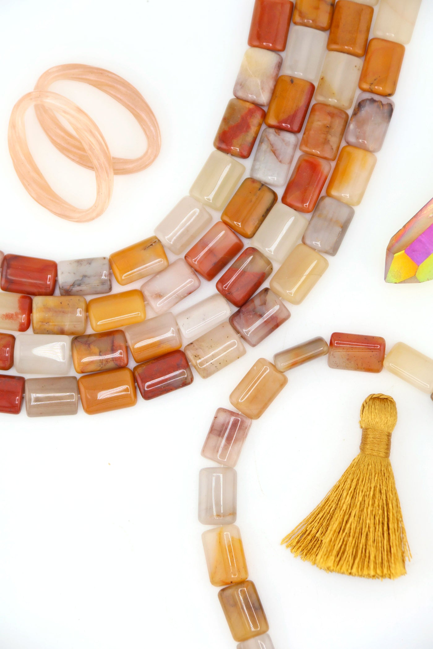 Strands of genuine Sansha Jasper puffed rectangle beads in warm earthy gold, cream, terracotta, and gray tones with a glossy finish