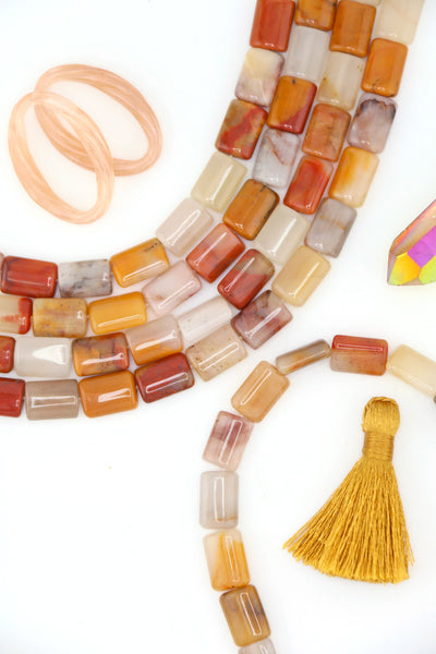 Strands of genuine Sansha Jasper puffed rectangle beads in warm earthy gold, cream, terracotta, and gray tones with a glossy finish