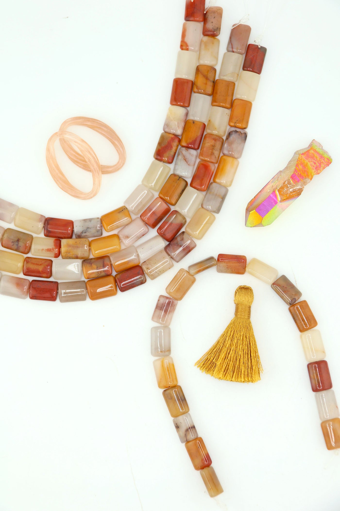 Strands of genuine Sansha Jasper puffed rectangle beads in warm earthy gold, cream, terracotta, and gray tones with a glossy finish