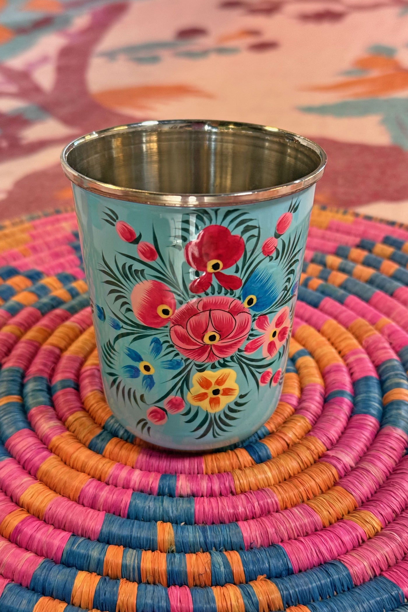 Sip in style with our picnic folk Small Enamel Tumbler, painted by hand by artisans in Kashmir