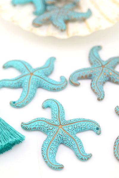 Turquoise German resin starfish pendants with intricate details, 48mm size, styled on white background.
