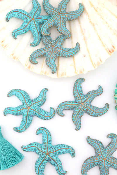 Turquoise German resin starfish pendants with intricate details, 48mm size, styled on white background.