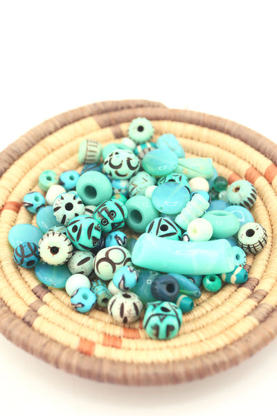 Turquoise bead grab bag displayed in a woven basket, with artisan-style beads in shades of teal, aqua, and turquoise.