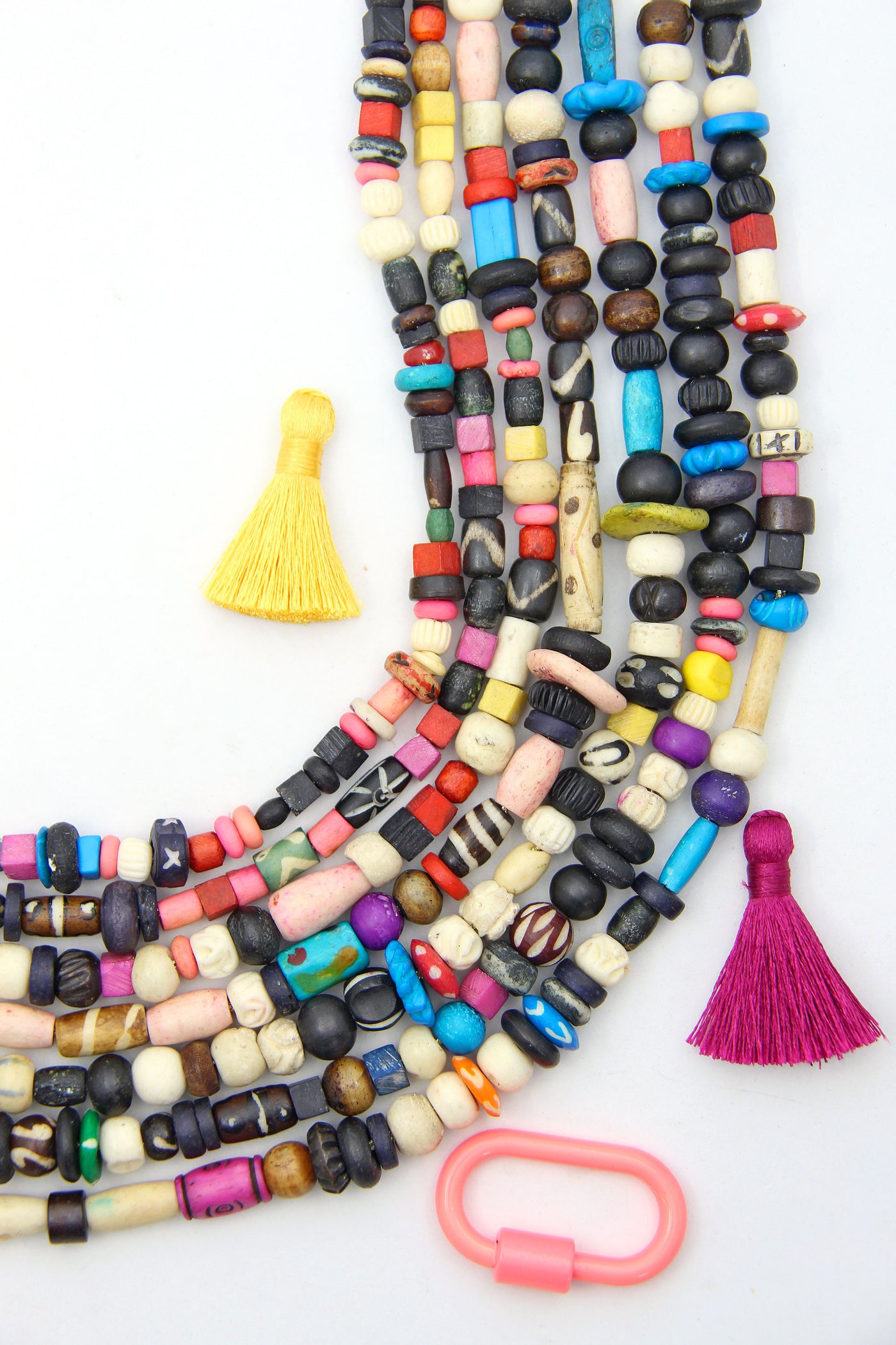 Assorted multi-color beads made from bone, for making bracelets and beaded jewelry