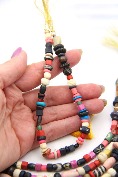 Assorted multi-color beads made from bone, for making bracelets and beaded jewelry