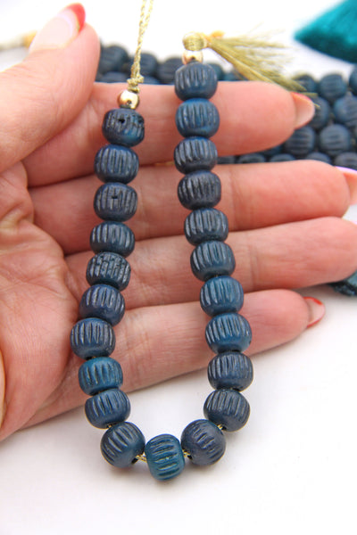 These deep green bone beads have the coolest carved melon pattern on them