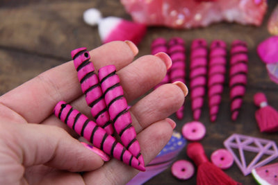 Hot Pink & Black Unicorn Horn Pendant: 2" Long Carved Bone Beads, 1 piece - ShopWomanShopsWorld.com. Bone Beads, Tassels, Pom Poms, African Beads.