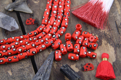 White Dotted Tubes: Hand Painted Red Bone Beads, 7x13mm, 16 pieces - ShopWomanShopsWorld.com. Bone Beads, Tassels, Pom Poms, African Beads.