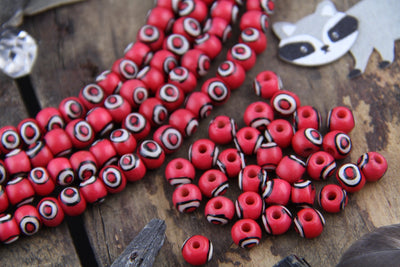 Red Bullseye Bone Beads, 6x8mm, 30 pieces - ShopWomanShopsWorld.com. Bone Beads, Tassels, Pom Poms, African Beads.