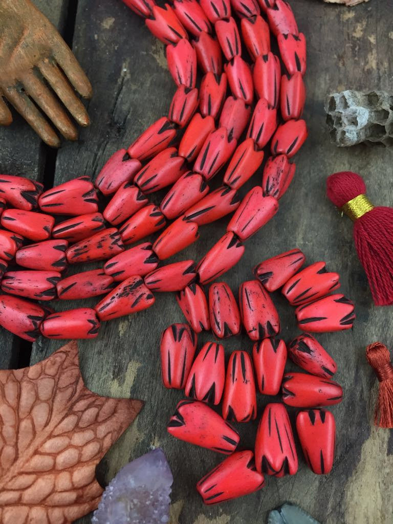 Orange Tribal Geometric Tulip: Hand Carved Bone Beads, 9x12mm, 16 pieces - ShopWomanShopsWorld.com. Bone Beads, Tassels, Pom Poms, African Beads.
