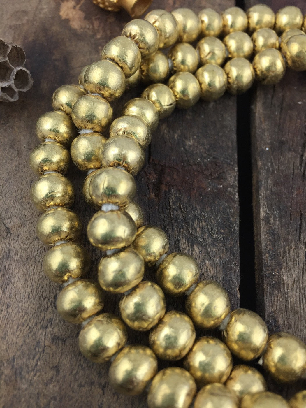 Golden Brass Round Seam Beads 8x6mm, from Ethiopia, African Metal Spacer Beads, Non-Tarnish Metal Jewelry Making Supply, 32" circular strand - ShopWomanShopsWorld.com. Bone Beads, Tassels, Pom Poms, African Beads.