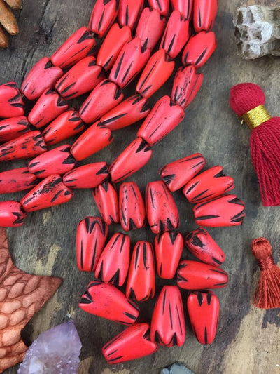 Orange Tribal Geometric Tulip: Hand Carved Bone Beads, 9x12mm, 16 pieces - ShopWomanShopsWorld.com. Bone Beads, Tassels, Pom Poms, African Beads.