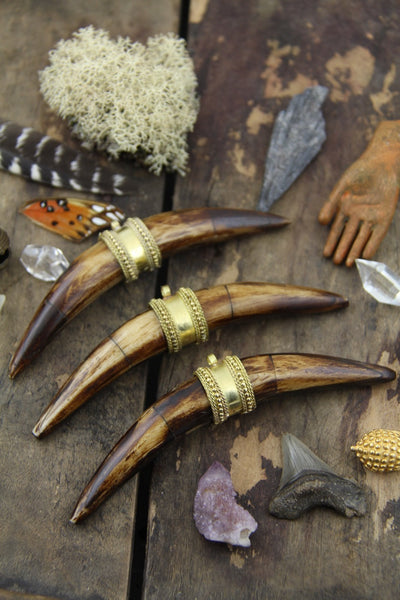 Brown Curved Crescent Tusk Pendant: 5", 1 piece - ShopWomanShopsWorld.com. Bone Beads, Tassels, Pom Poms, African Beads.