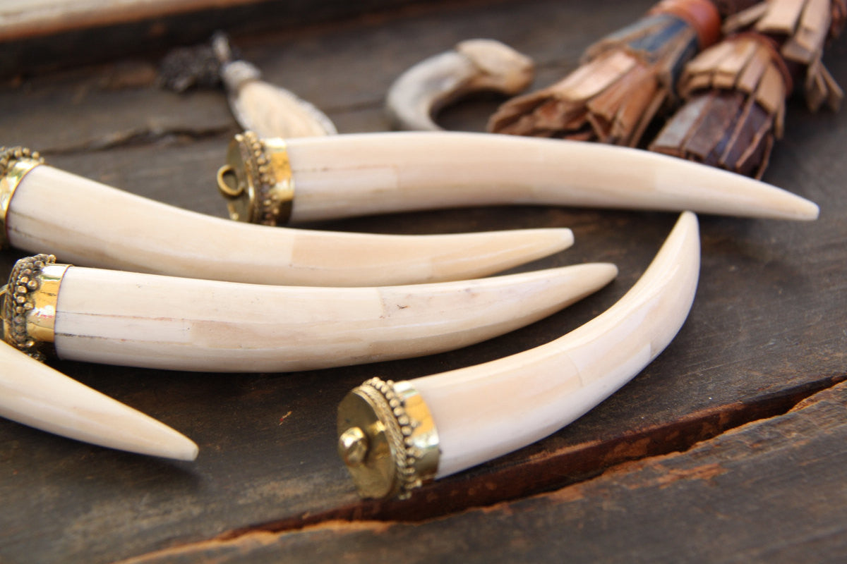 Large Tusk: 5" Natural Bone & Brass Pendant, 1 piece - ShopWomanShopsWorld.com. Bone Beads, Tassels, Pom Poms, African Beads.