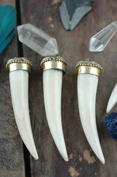 Small Tusk: 3" Bone & Brass Pendant, 1 piece - ShopWomanShopsWorld.com. Bone Beads, Tassels, Pom Poms, African Beads.